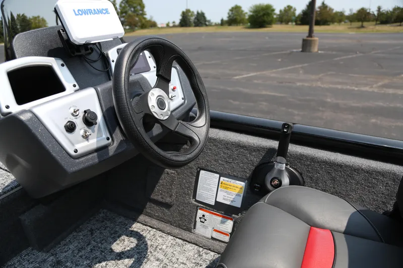 Slide: The Image of 2026 Tracker Pro Team 175 Crappie Edition boat interior with steering wheel and controls. - 4