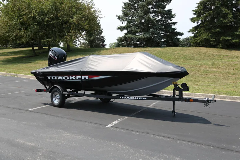 Slide: The Image of 2026 Tracker Pro Team 175 Crappie Edition boat on trailer, covered, in parking lot. - 6