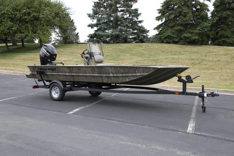The Image of 2026 Tracker Grizzly 1860 CC boat on trailer in parking lot. - 0