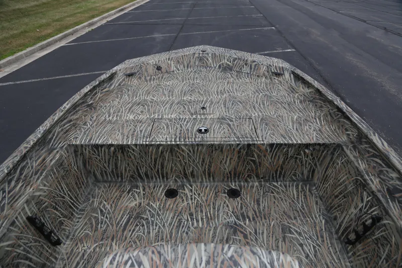 Slide: The Image of 2026 Tracker Grizzly 1860 CC boat with camouflage pattern on a paved surface. - 3