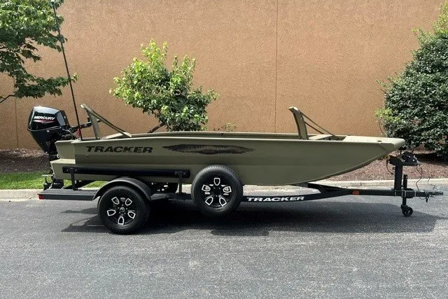 The Image of 2026 Tracker Grizzly 1650 T Prairie Wings Edition boat on trailer, parked outdoors. - 0