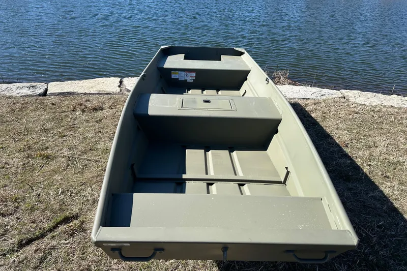 Slide: The Image of 2026 Tracker Grizzly 15 Jon boat on grassy shore by water. - 3