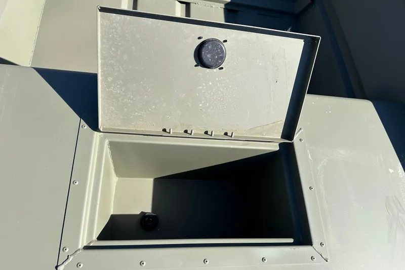 Slide: The Image of Open storage compartment on 2026 Tracker Grizzly 15 Jon boat, showcasing interior details. - 7