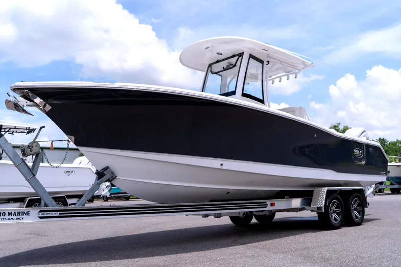 The Image of 2026 Sea Hunt Ultra 265 SE boat on trailer under clear sky. - 0