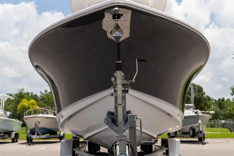 Slide: The Image of 2026 Sea Hunt Ultra 265 SE boat on trailer, front view, parked outdoors. - 11