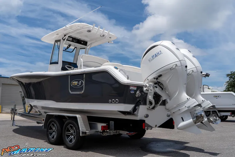 Slide: The Image of 2026 Sea Hunt Ultra 265 SE boat with dual Yamaha engines on a trailer. - 13