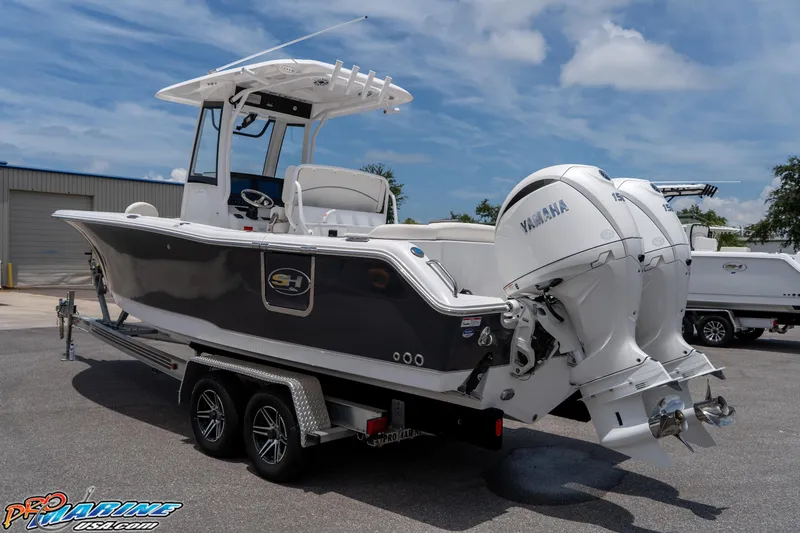 Slide: The Image of 2026 Sea Hunt Ultra 265 SE boat with dual Yamaha engines on a trailer. - 14