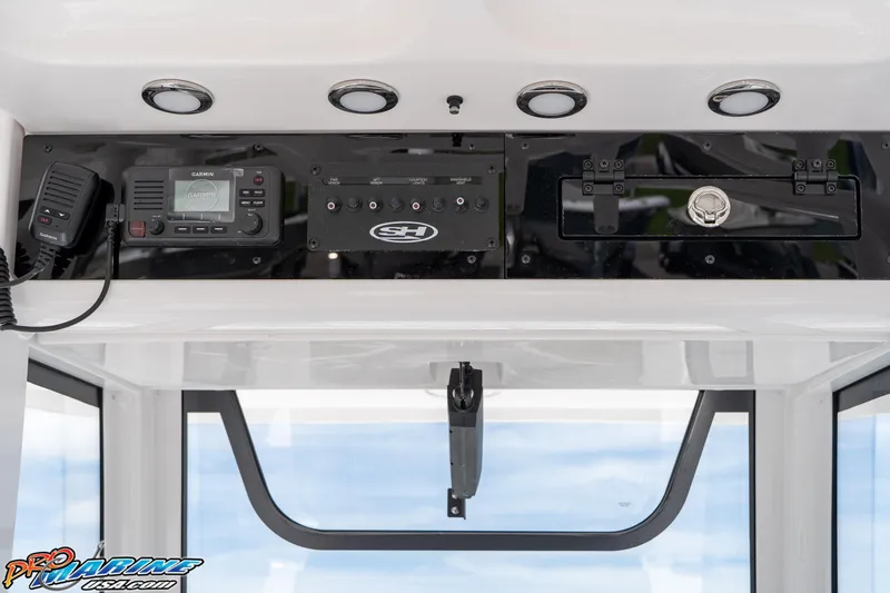 Slide: The Image of 2026 Sea Hunt Ultra 265 SE dashboard with Garmin electronics and control panel. - 26