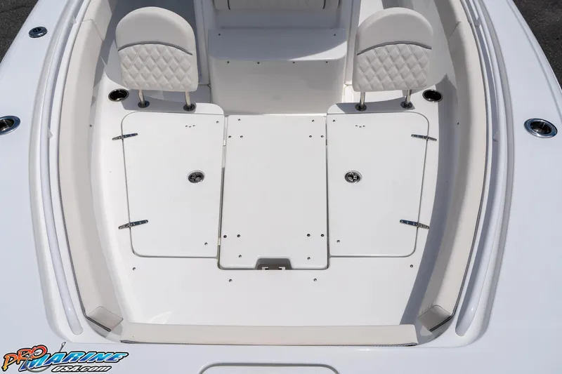 Slide: The Image of 2026 Sea Hunt Ultra 265 SE boat interior with white seating and storage compartments. - 32