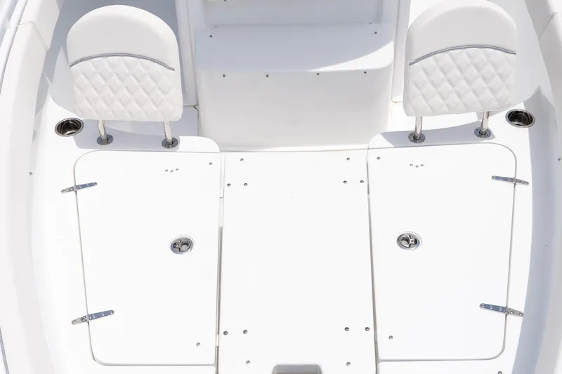 Slide: The Image of 2026 Sea Hunt Ultra 265 SE boat interior with white seating and storage compartments. - 33