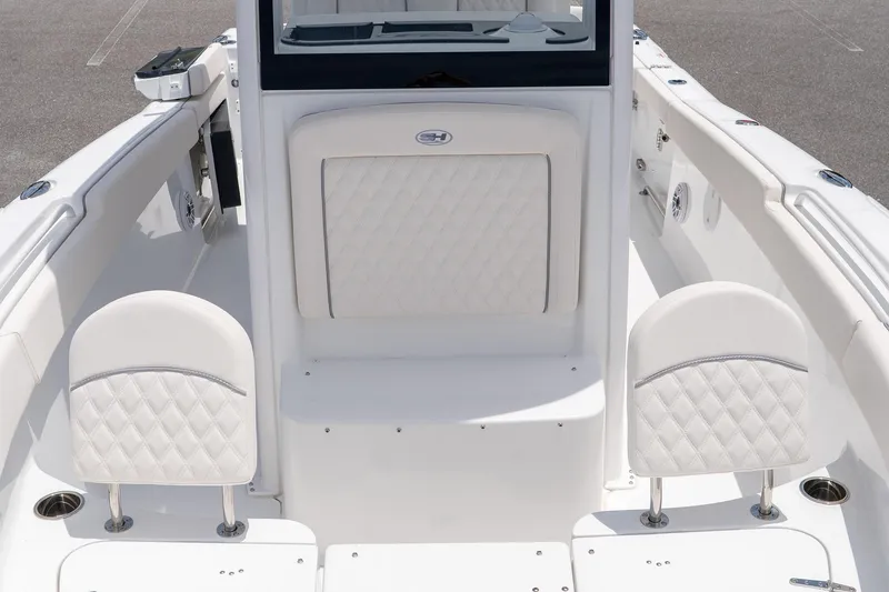 Slide: The Image of 2026 Sea Hunt Ultra 265 SE boat interior with white cushioned seating. - 34