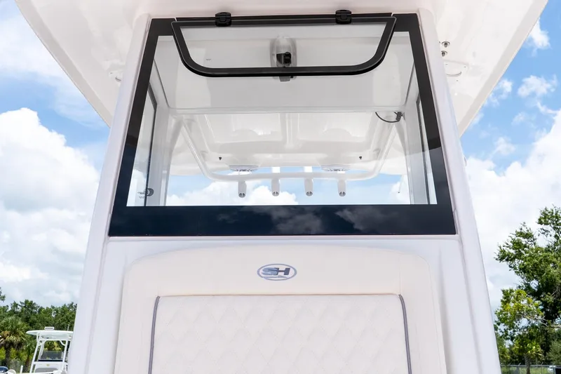 Slide: The Image of 2026 Sea Hunt Ultra 265 SE boat console with clear windshield and blue sky background. - 35