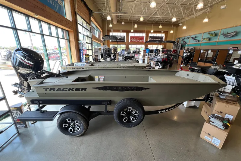The Image of 2026 Tracker Grizzly 1650 T Prairie Wings Edition boat on trailer, autumn background. - 0