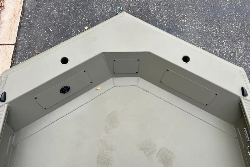 Slide: The Image of Bow of 2026 Tracker Grizzly 1650 T Prairie Wings Edition boat, showing storage compartments. - 4