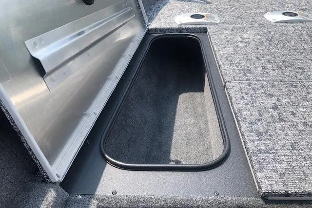 Slide: The Image of 2026 Tracker Pro Team 175 Crappie Edition boat storage compartment, open and empty. - 11