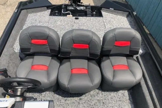 Slide: The Image of 2026 Tracker Pro Team 175 Crappie Edition boat with four gray and red seats. - 17