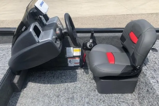 Slide: The Image of 2026 Tracker Pro Team 175 Crappie Edition boat interior with steering console and seat. - 18