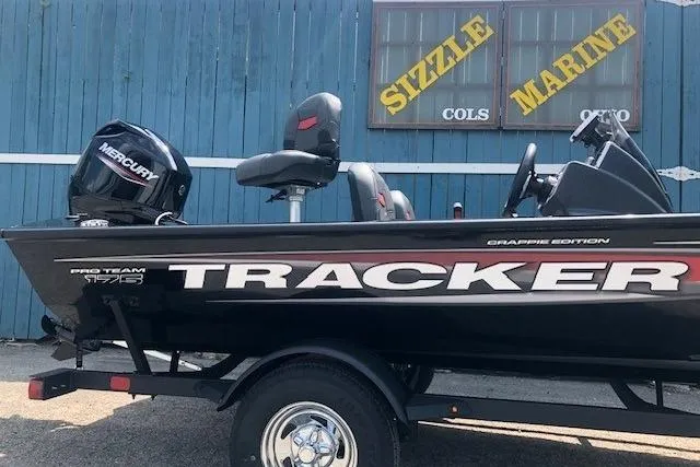 Slide: The Image of 2026 Tracker Pro Team 175 Crappie Edition boat with Mercury engine, parked at Sizzle Marine. - 2