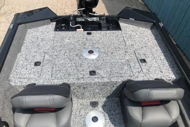 Slide: The Image of 2026 Tracker Pro Team 175 Crappie Edition boat interior with gray seating and carpeted deck. - 23