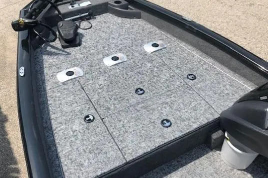 Slide: The Image of 2026 Tracker Pro Team 175 Crappie Edition boat deck with gray carpet and storage compartments. - 8