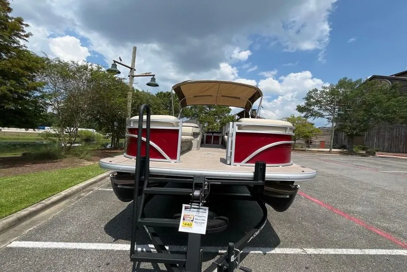 Slide: The Image of 2025 Sun Tracker Party Barge 24 DLX pontoon boat in parking lot, rear view. - 6