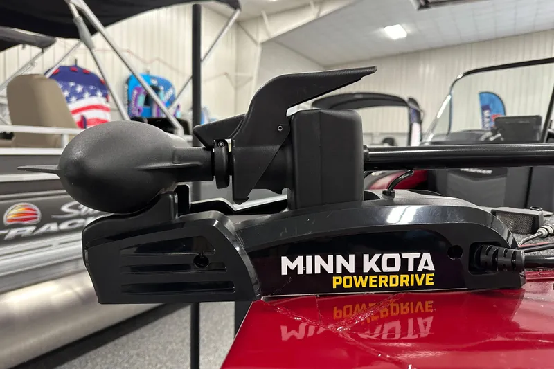 Slide: The Image of 2026 Tracker Targa V-18 WT boat interior with seating and control panel in showroom. - 10