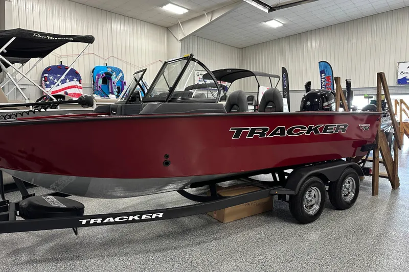 Slide: The Image of 2026 Tracker Targa V-18 WT boat displayed indoors on a trailer. - 3