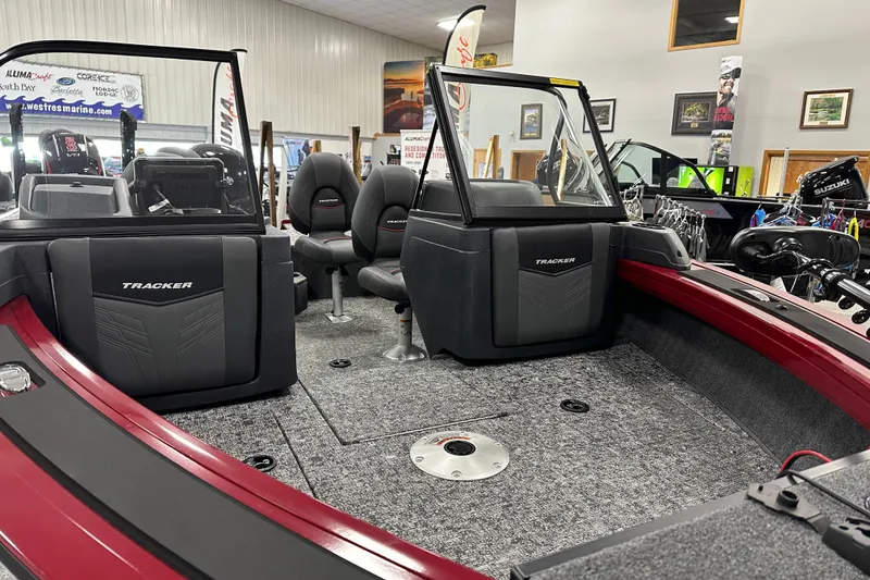 Slide: The Image of 2026 Tracker Targa V-18 WT boat interior with seating and dashboard in showroom. - 4