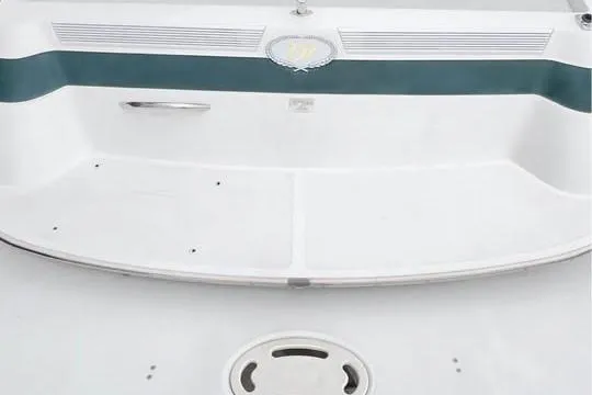 Slide: The Image of Rear view of a 2000 Cobalt 252 boat with a white and teal design. - 11