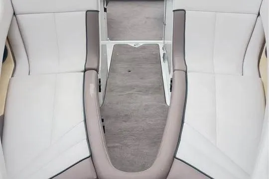 Slide: The Image of Interior seating of a 2000 Cobalt 252 boat, featuring gray and white upholstery. - 12