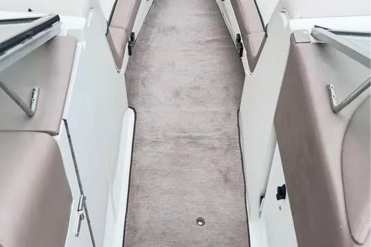 Slide: The Image of Interior view of a 2000 Cobalt 252 boat with beige seating and carpeted floor. - 13