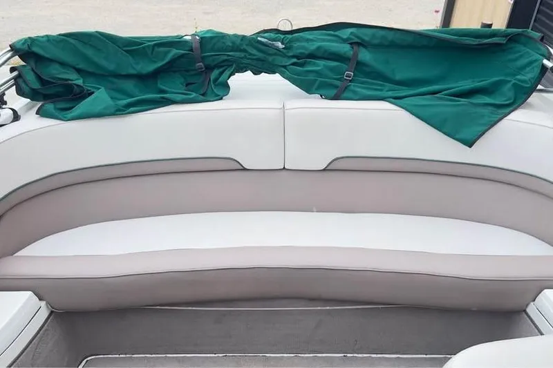 Slide: The Image of Interior seating of a 2000 Cobalt 252 boat with green cover. - 6