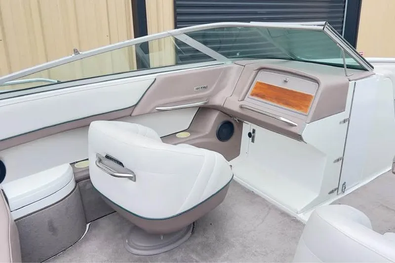 Slide: The Image of Interior of a 2000 Cobalt 252 boat with white and beige seating. - 8