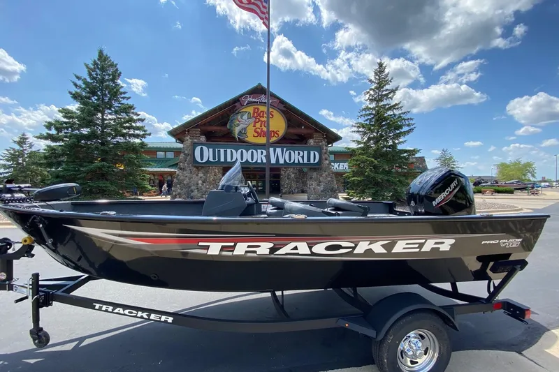 The Image of 2026 Tracker Pro Guide V-16 SC boat displayed outside Outdoor World store. - 0