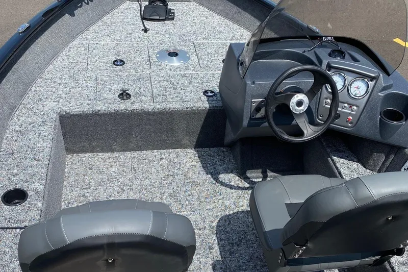 Slide: The Image of 2026 Tracker Pro Guide V-16 SC boat interior with steering console and seating. - 5