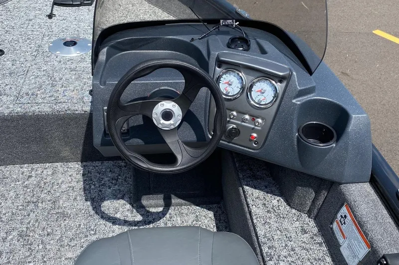 Slide: The Image of 2026 Tracker Pro Guide V-16 SC boat dashboard with steering wheel and gauges. - 6