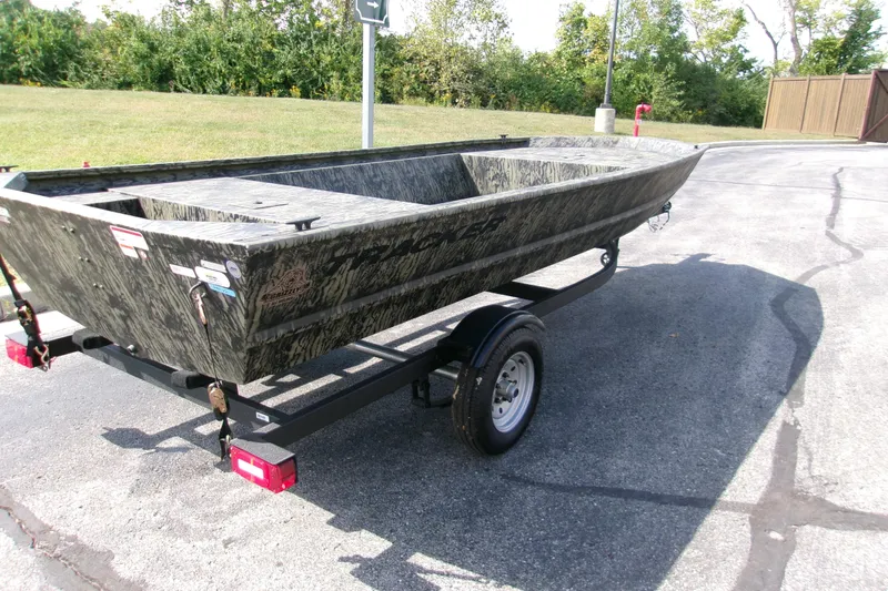 Slide: The Image of 2026 Tracker Grizzly 1648 Utility boat on trailer, parked outdoors. - 2