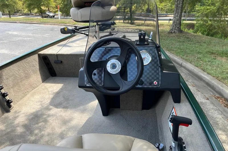 Slide: The Image of 2026 Tracker Bass Tracker Classic Limited boat interior with steering wheel and dashboard. - 7