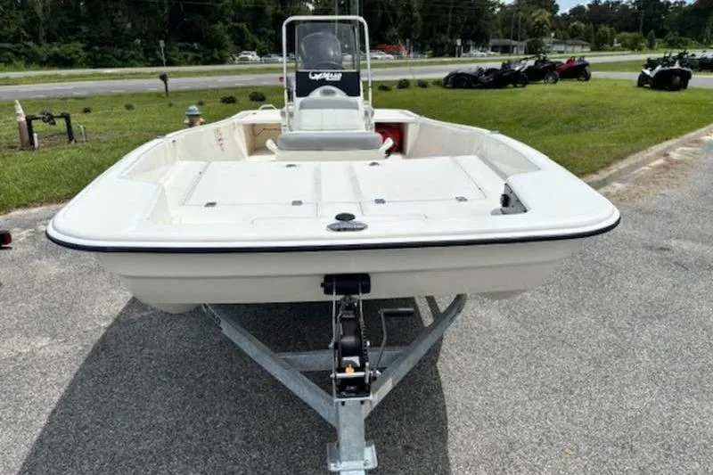 Slide: The Image of 2026 Mako Pro Skiff 17 CC boat on trailer, parked outdoors. - 2