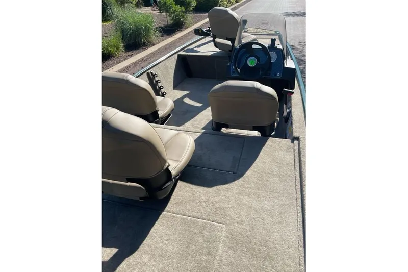 Slide: The Image of 2026 Tracker Bass Tracker Classic Limited boat interior with beige seats and steering console. - 5