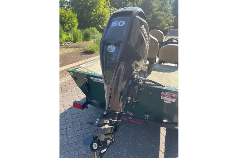 Slide: The Image of 2026 Tracker Bass Tracker Classic Limited boat with Mercury 50 engine, parked outdoors. - 6