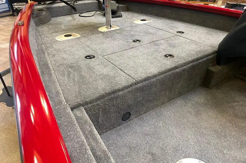 Slide: The Image of 2026 Tracker Pro Team 175 Crappie Edition boat interior with gray carpet and red trim. - 8