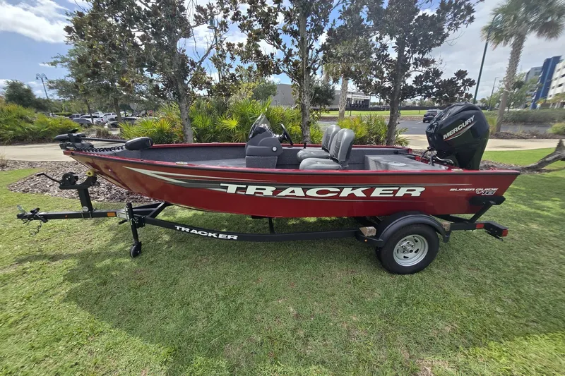 Slide: The Image of 2026 Tracker Super Guide V-16 SC boat on trailer, parked on grass. - 49