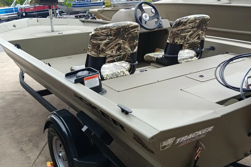 Slide: The Image of 2026 Tracker Grizzly 1754 SC boat with camo seats and steering console. - 4