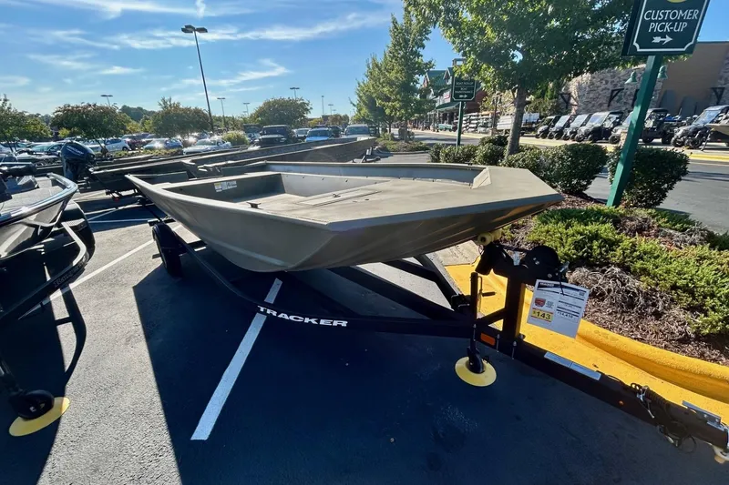 Slide: The Image of 2026 Tracker Grizzly 2072 Utility boat with Mercury outboard motor in parking lot. - 2