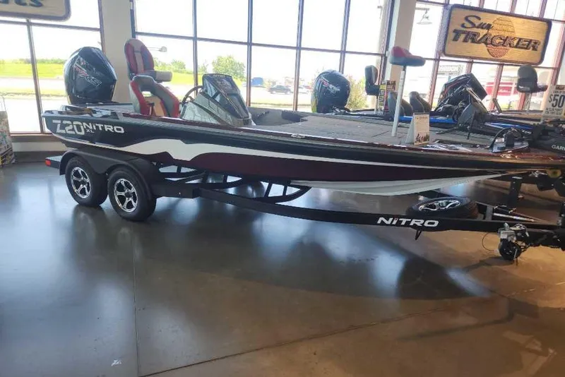 The Image of 2026 Nitro Z20 XL Pro boat displayed indoors with trailer and outboard motor. - 0