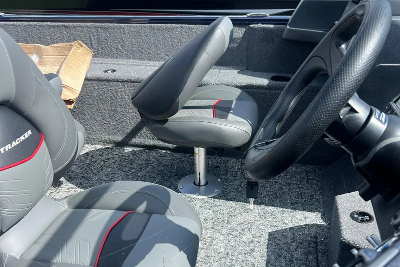 Slide: The Image of 2026 Tracker Pro Guide V-175 WT boat interior with gray seats and steering wheel. - 4