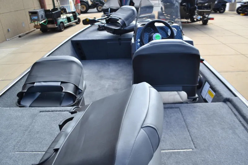 Slide: The Image of 2026 Tracker Bass Tracker Classic XL boat interior with seating and steering console. - 3