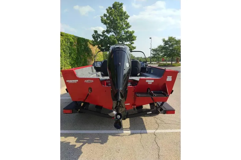 Slide: The Image of 2026 Tracker Pro Guide V-175 WT boat, red exterior, parked outdoors. - 97