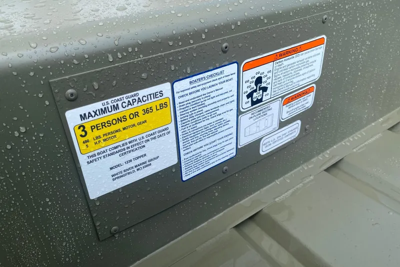 Slide: The Image of Tracker Grizzly 12 Jon 2026 boat safety labels, maximum capacity 3 persons or 365 lbs. - 2